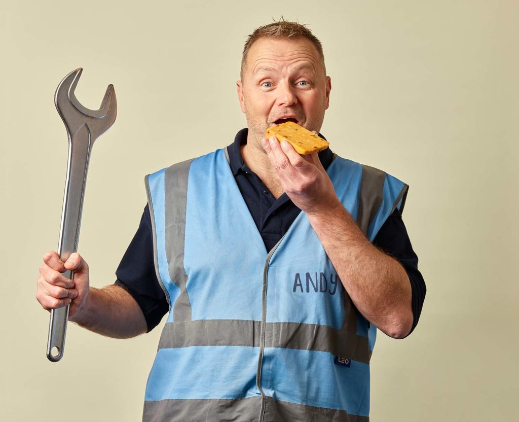 Engineering man eating a block of Mexicana cheese