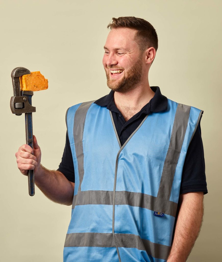 Engineering man holding a block of Mexicana cheese