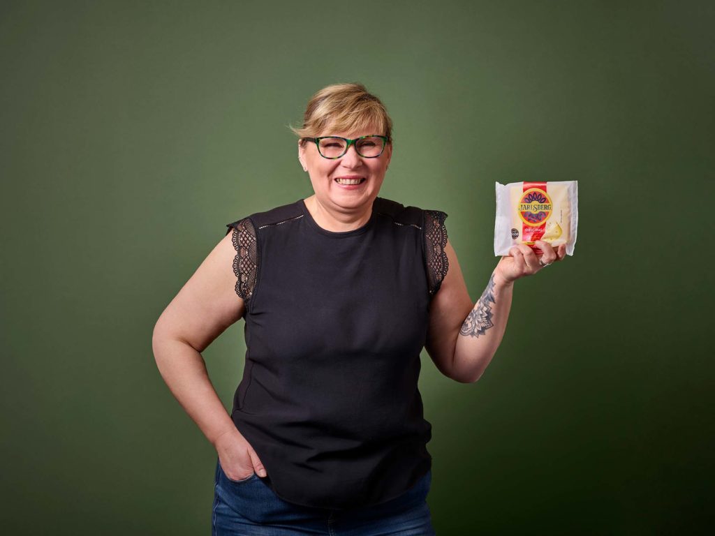 Woman with a block of Jarlsberg cheese