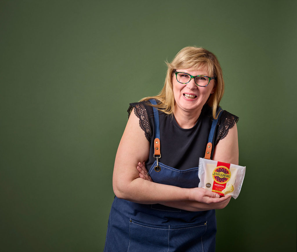 Woman with a block of Jarlsberg cheese